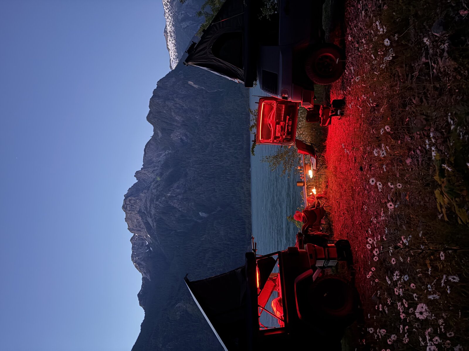 Dispersed camping at dusk with rooftop tents and mountains